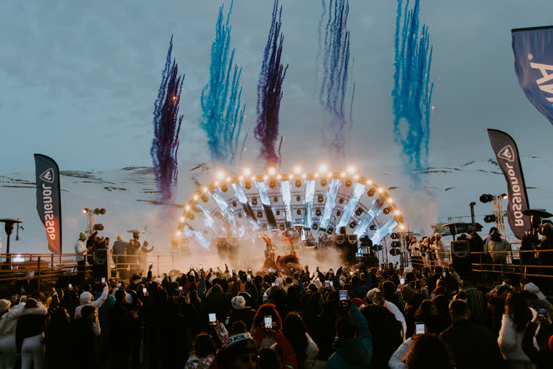 Colored smoke over The Summit Fest stage in the snow